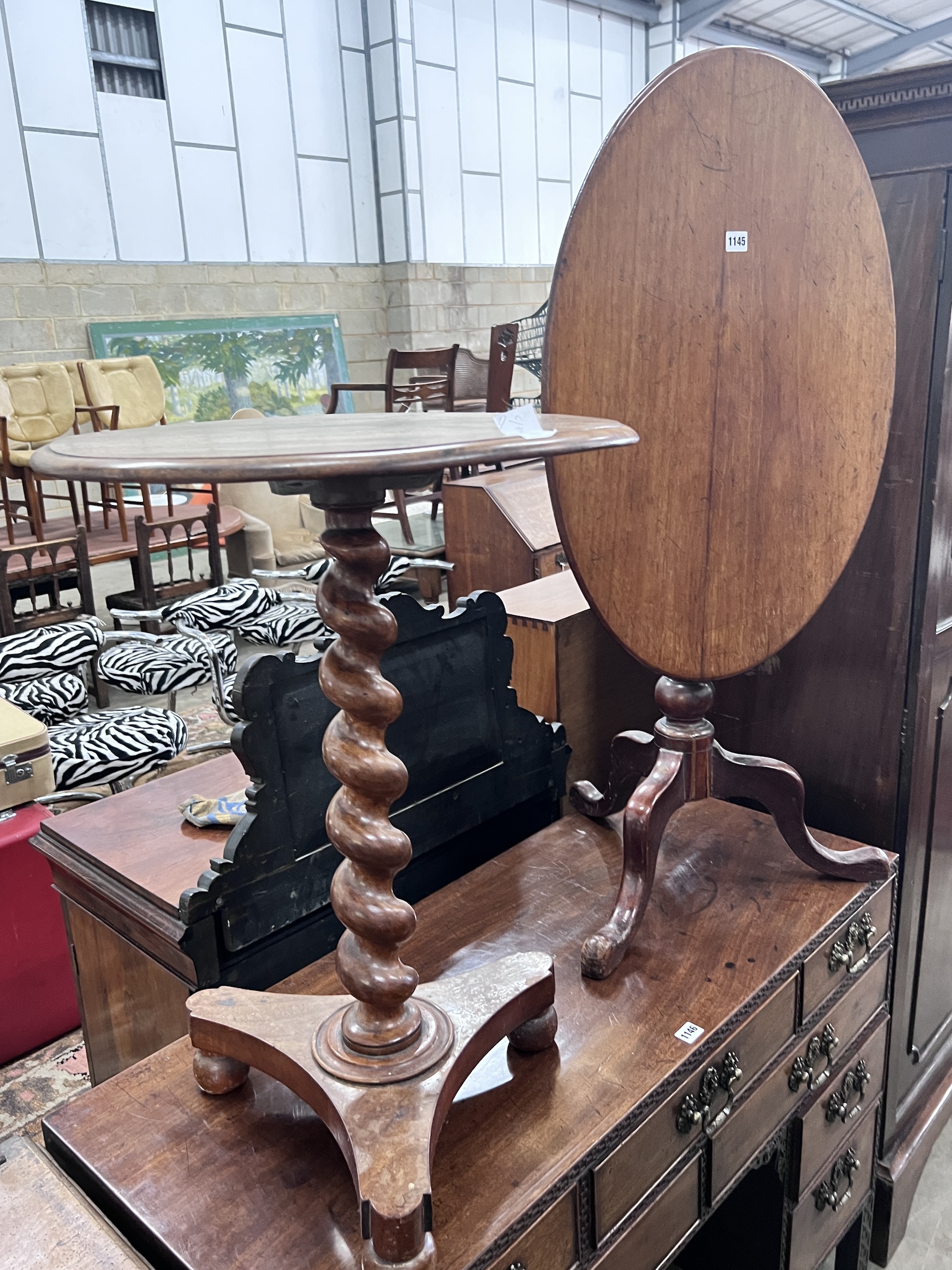A Victorian spiral stem circular mahogany wine table, diameter 50cm, height 71cm, together with a Victorian oval mahogany tilt top tripod table
